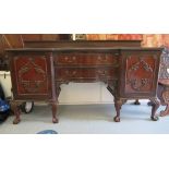 A 1920s mahogany serpentine front sideboard with two central drawers, flanked by two panelled doors,