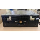 A simulated snakeskin travel case with a part-fitted interior and combination locks  8" x 22" x 21"