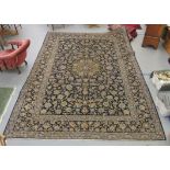 A Keshan carpet, decorated with dense floral motifs, on a blue ground  157" x 104"