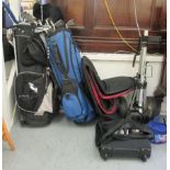 Two bags of golf clubs: to include a Wilson driver and other irons; a trolley; a pair of FootJoy