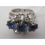 An 18ct white gold ring, set with three central sapphires, flanked by four diamonds