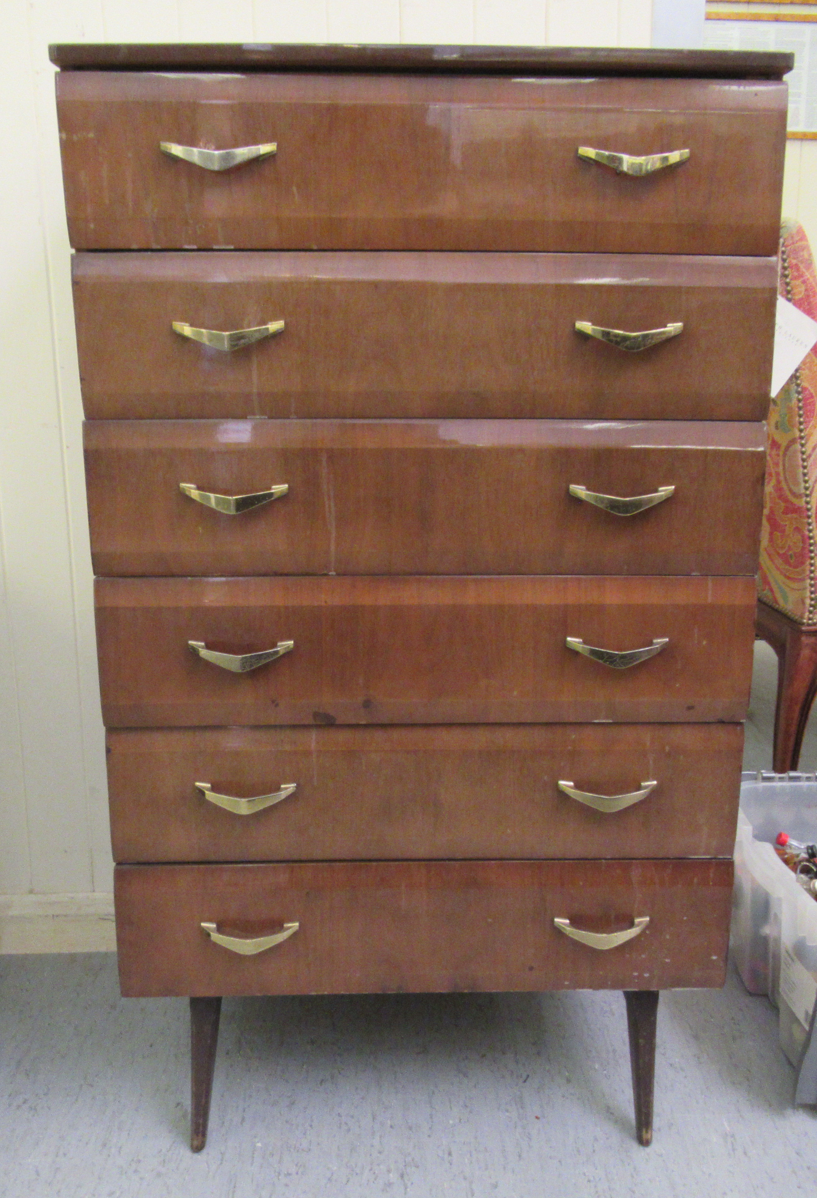 A mid 20thC mahogany finished six drawer dressing chest, raised on tapered legs  45"h  26"w