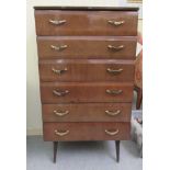 A mid 20thC mahogany finished six drawer dressing chest, raised on tapered legs  45"h  26"w