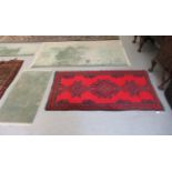 Three Chinese woollen rugs, each on a green ground  largest 54" x 91"; and a Persian rug,