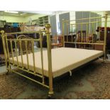 A Victorian style lacquered brass double bed frame, on cast iron supports and casters, the head 60"w