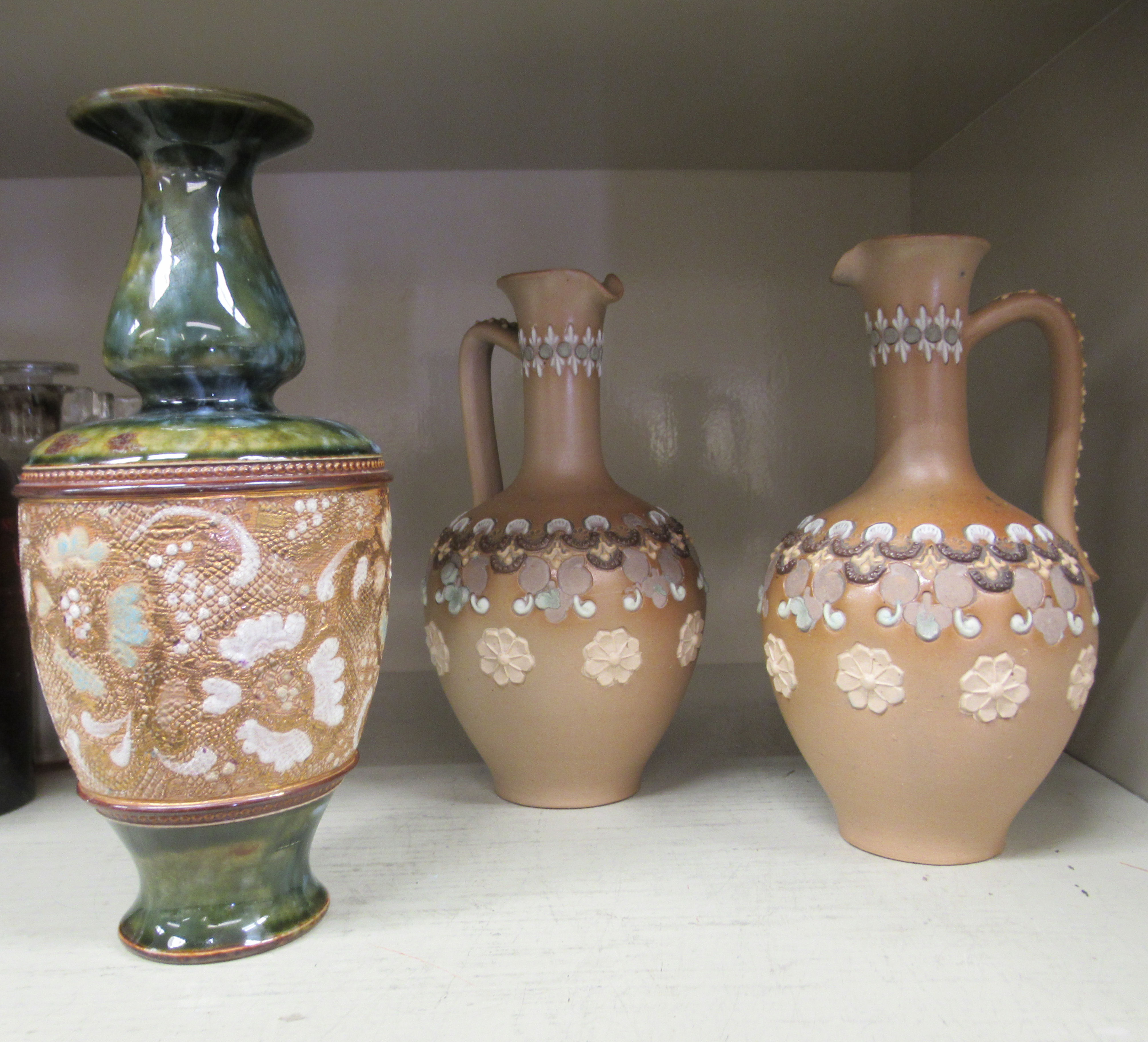 A pair of Doulton Lambeth Silicon Ware ewers  7"h; and a Royal Doulton stoneware vase with lace