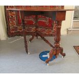 A late Victorian walnut Sutherland table, the quartered and figured oval top, raised on tulip carved