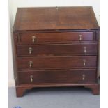 A 1930s oak bureau, the fall flap over four graduated drawers, raised on bracket feet  39.5"h  36"w