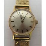 A lady's Omega 9ct gold cased wristwatch, faced by a baton dial, on a 9ct gold flexible strap
