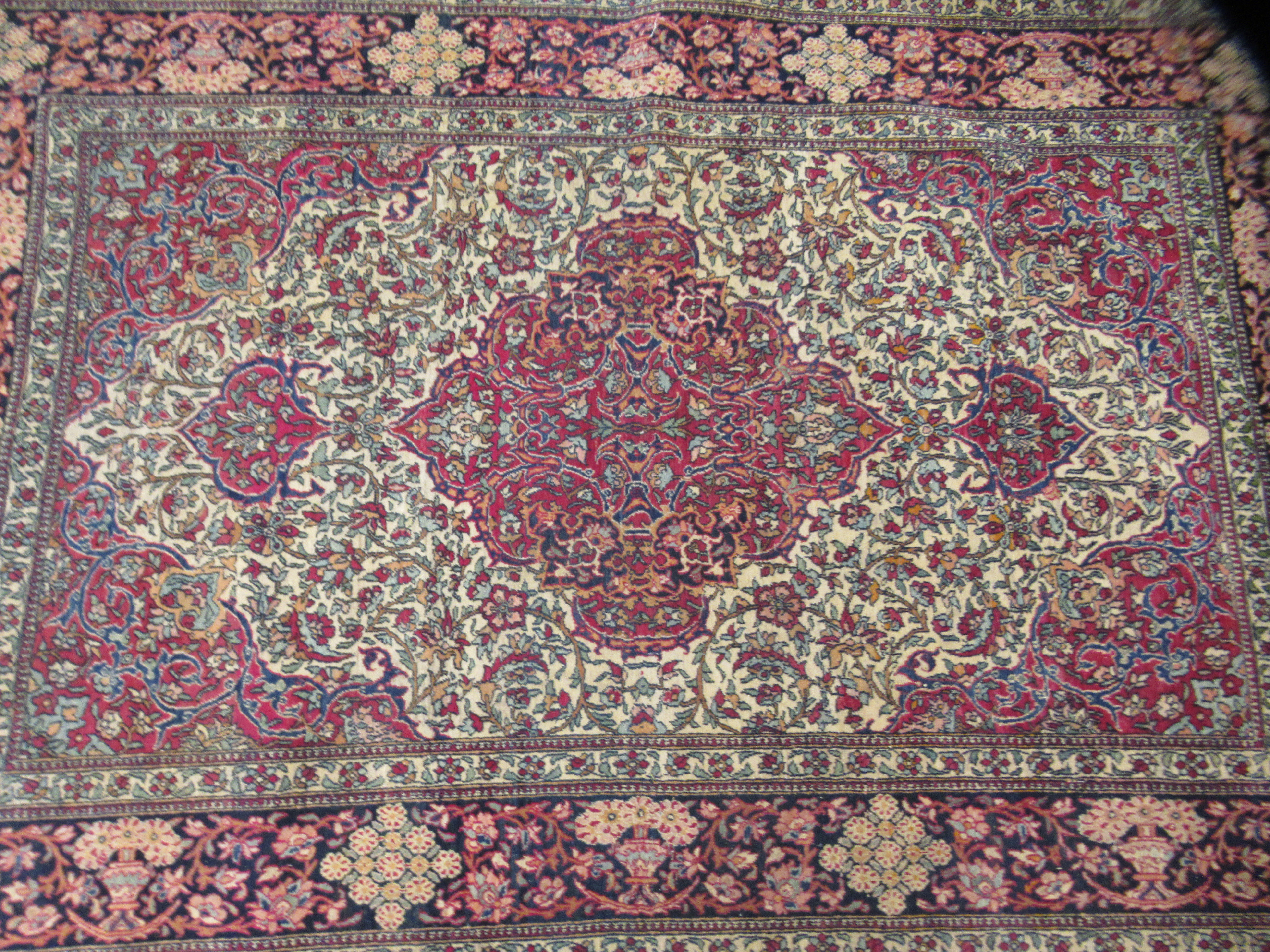 A Persian rug, decorated with a serpentine outlined medallion, bordered by stylised designs on a - Image 2 of 4