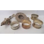 Silver collectables: to include a rattle, napkin rings and a tea strainer  mixed marks