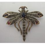 A white metal dragonfly brooch, set with diamonds, sapphires and rubies