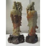 A matched pair of 20thC Chinese carved green and brown soapstone standing figures, each with a