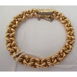 A 15ct gold fancy link bracelet, on a bayonet clasp and safety chain