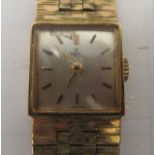 A lady's Ebel 9ct gold cased wristwatch, faced by a baton dial, on a 9ct gold flexible strap