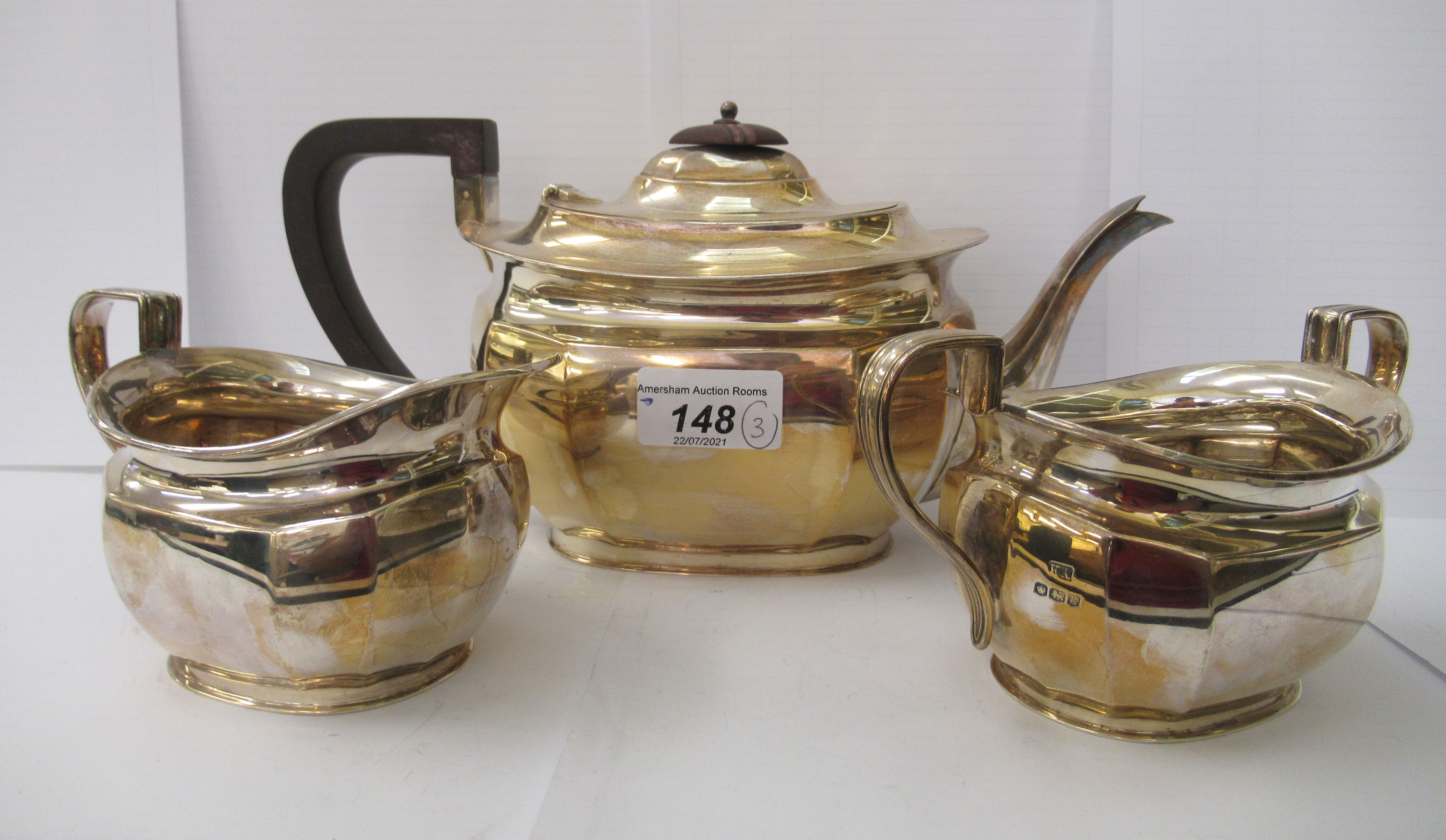 A three piece George V silver tea set  comprising a teapot, a cream jug and sugar basin