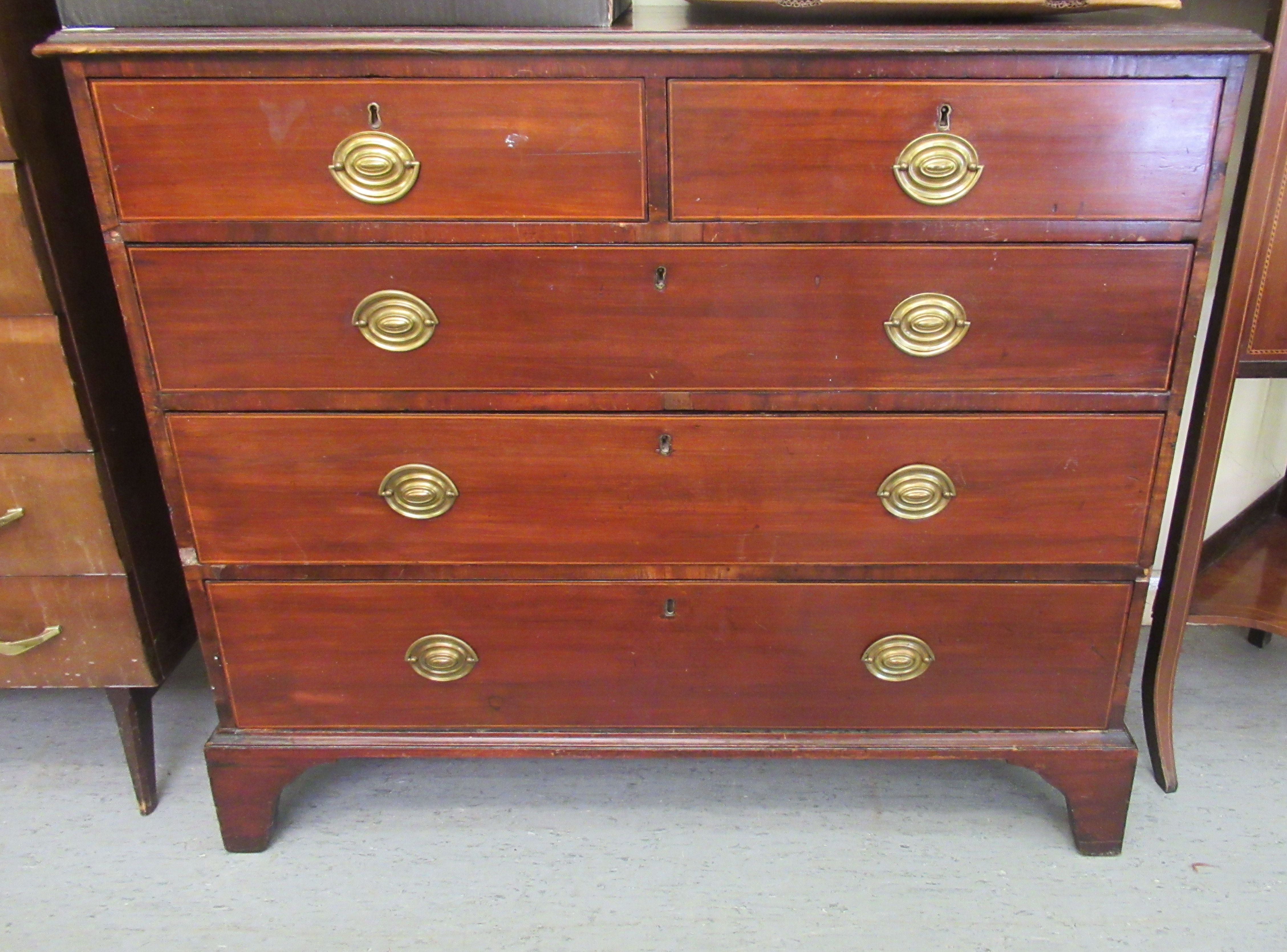 An Edwardian string inlaid mahogany dressing chest, comprising two short/three long drawers,