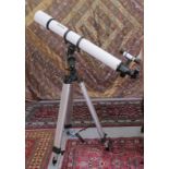 A Meade telescope with a 6x30mm lens  41"L, on a tripod stand  38"h
