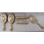 A five piece Art Nouveau period silver backed dressing table set  comprising four brushes and a hand
