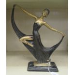 A cast and part painted bronze figure, a 1920s dancer, on a plinth  15"h