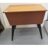 A 1950/60s teak sewing box, on splayed, ebonised legs  20"h  21"w