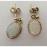 A pair of 9ct gold, opal set drop earrings