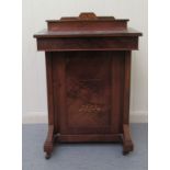 An Edwardian string inlaid walnut Davenport, the rising hinged top set with a tooled and gilded