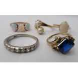 Three yellow metal rings and a white metal coloured ring, set with simulated pearls, opals and other