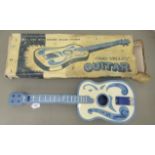 A child's 1950s Chad Valley painted tinplate toy guitar  boxed