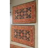A pair of Persian rugs, decorated with stylised designs, on a multi-coloured ground  30" x 48"