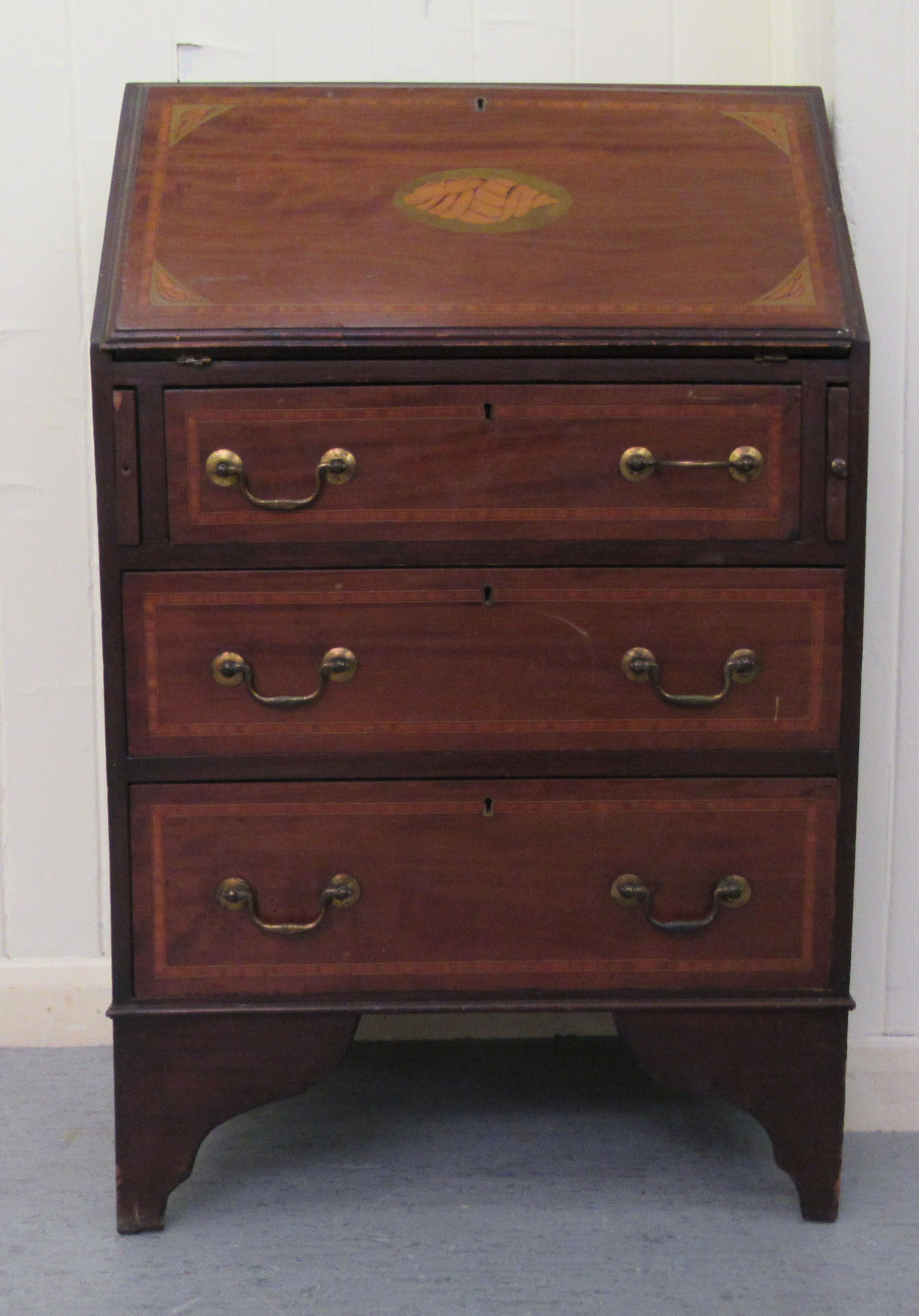 An Edwardian crossbanded string inlaid mahogany bureau bookcase, the fall flap over three long