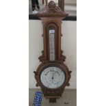 A late Victorian walnut barometer, the porcelain dials inscribed TB Winter & Son  35"h