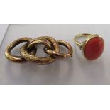 A 14ct gold ring, set with an oval coral coloured stone; and a rolled gold, five ring brooch