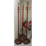 Three similar 20thC mahogany and beech standard lamps  63", 63" & 60"h