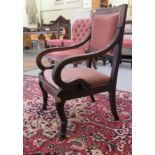 An Empire Period mahogany framed elbow chair, having a square back, swept, reed carved and foliate