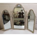 A 20thC cream coloured and gilt painted kidney shaped dressing table, surmounted by a triptych
