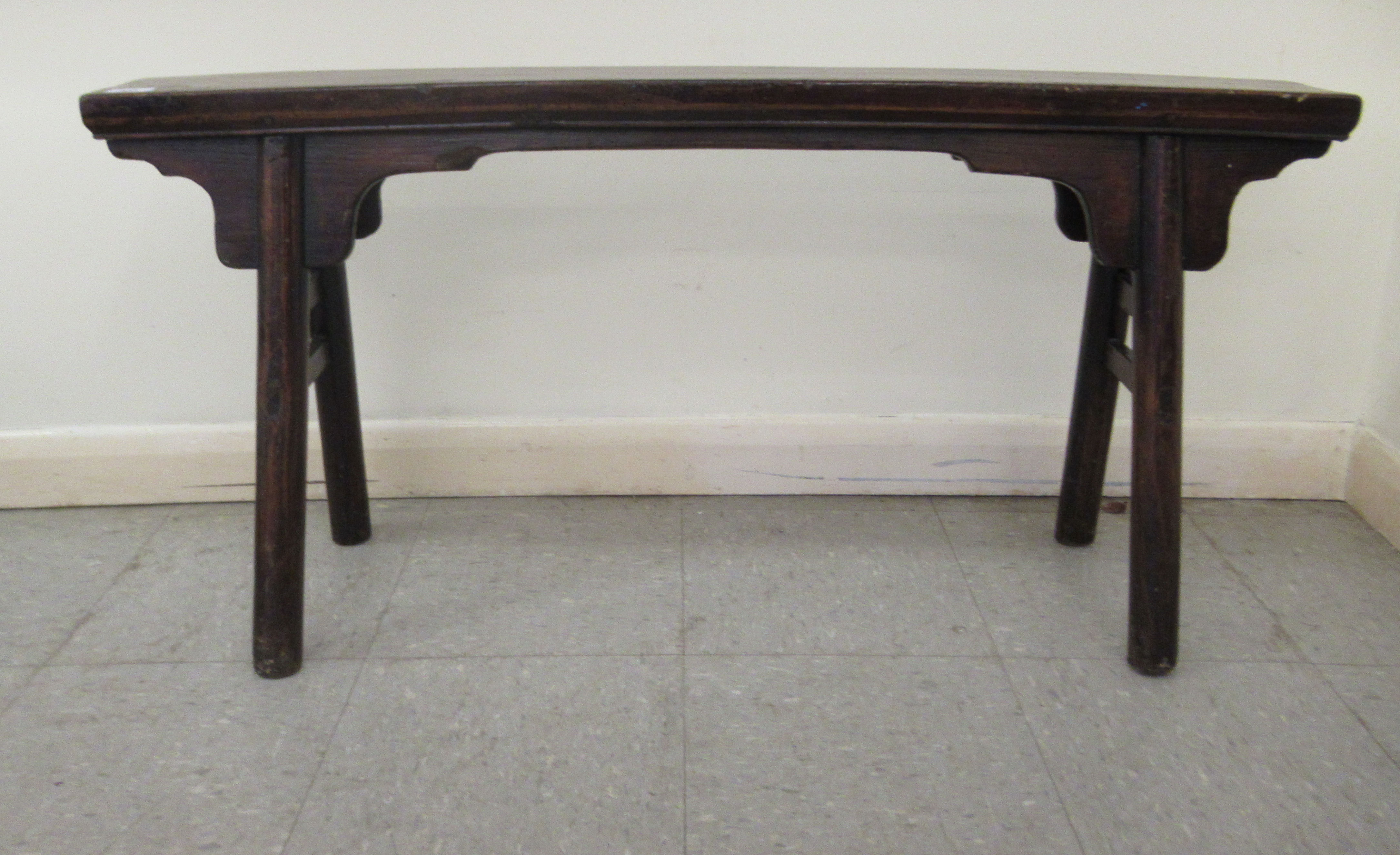 An early 20thC Chinese rustic elm bench, raised on turned, outset legs  21"h  44"w