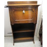 A 1920/30s oak student's bureau with a fall front, over two open shelves, raised on splayed feet