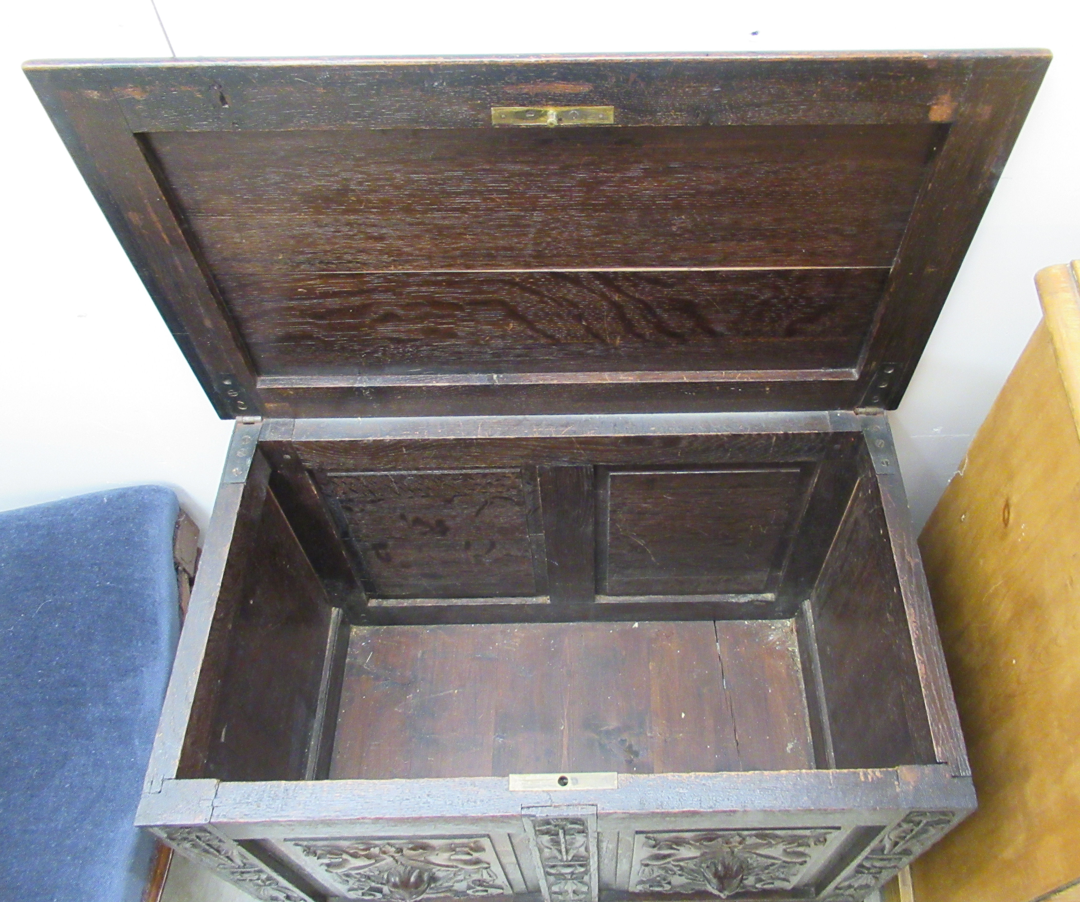 A late Victorian oak coffer with a hinged lid, over a twin panelled front and carved mask motifs, on - Image 3 of 3