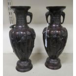 A pair of early 20thC Japanese bronze vases, decorated in relief, flora, birds and foliage  13.75"h