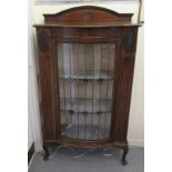 An early 20thC mahogany bowfront display cabinet, the top with an upstand, over a lead glazed