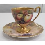 A Royal Worcester china matched pedestal coffee cup and saucer, decorated with soft fruit and