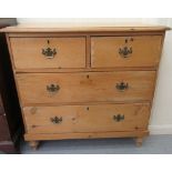A late Victorian stained pine dressing chest, comprising two short/two long drawers, raised on