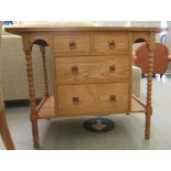 An Edwardian style light oak washstand with two short/two long central drawers, flanked by