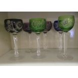 Seven similar decoratively cut hock glasses with coloured bowls