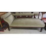 A late Victorian mahogany chaise longue with an upholstered back and seat, raised on turned, tapered