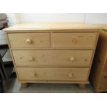 A modern stained pine four drawer dressing chest, raised on turned legs  31"h  35"w