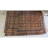 A Balochistan rug, decorated with repeating stylised designs, on a brown ground  35" x 42"
