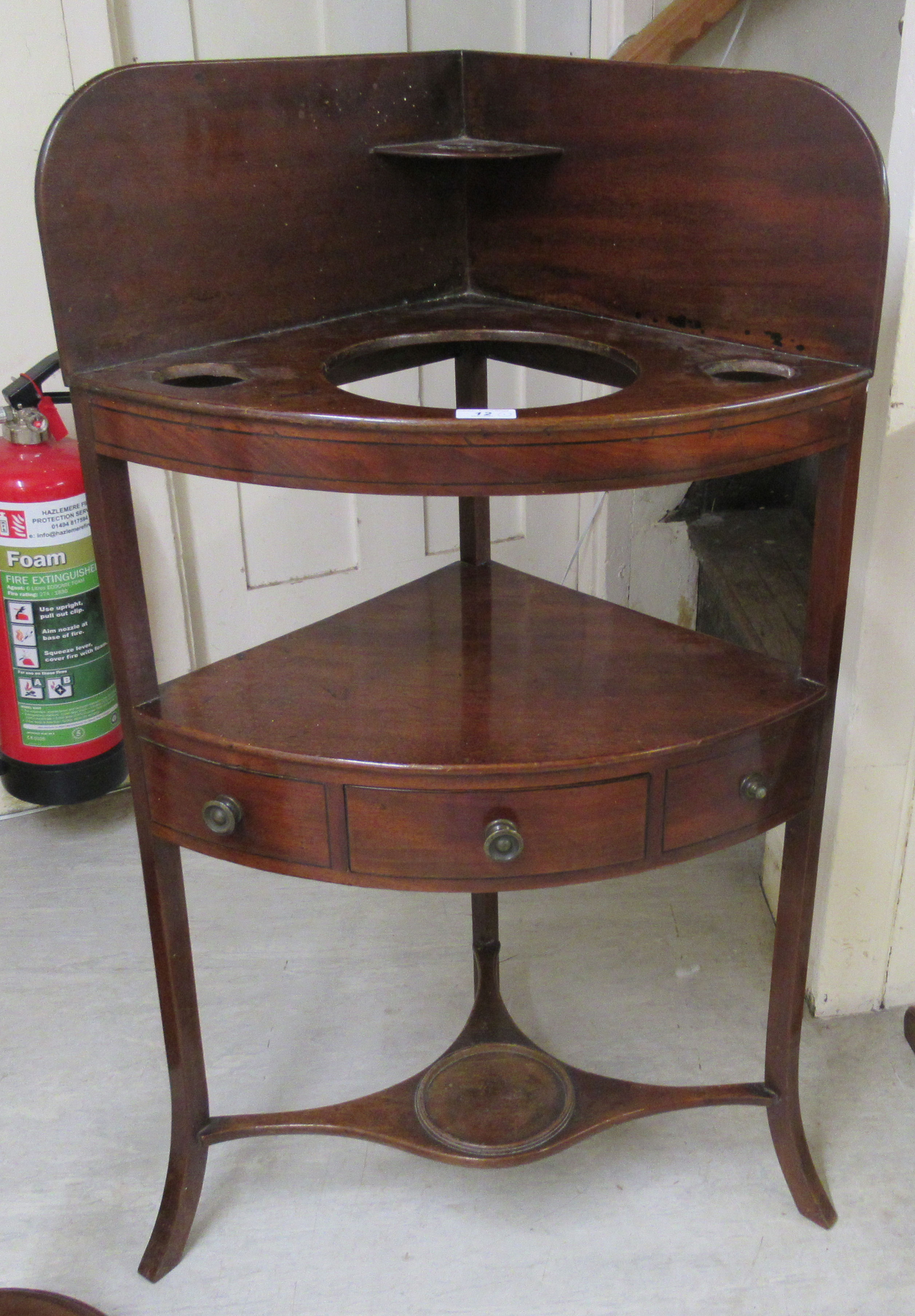 A George III mahogany quadrant washstand, raised on splayed legs  40"h  22"w