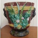 An early 20thC Majolica jardinière with opposing mask ornament, foliage and flora  18.5"dia